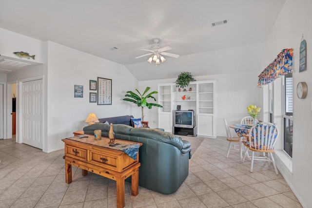 living area with light tile patterned floors, ceiling fan, and lofted ceiling