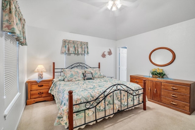 carpeted bedroom featuring vaulted ceiling and ceiling fan