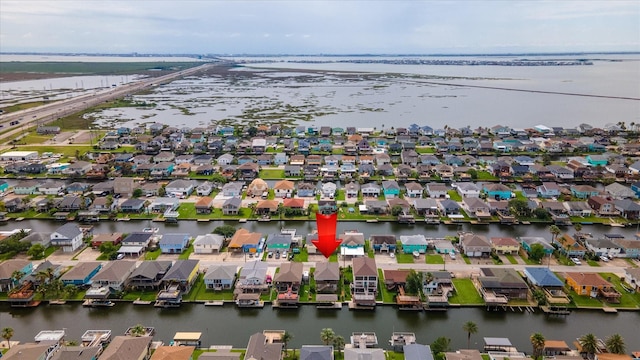 aerial view of residential area featuring a large body of water