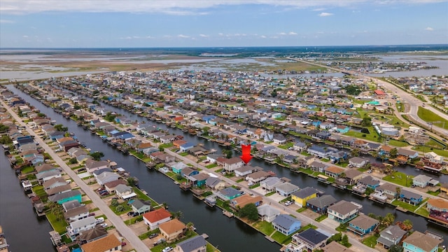 aerial view of property and surrounding area with nearby suburban area and a large body of water