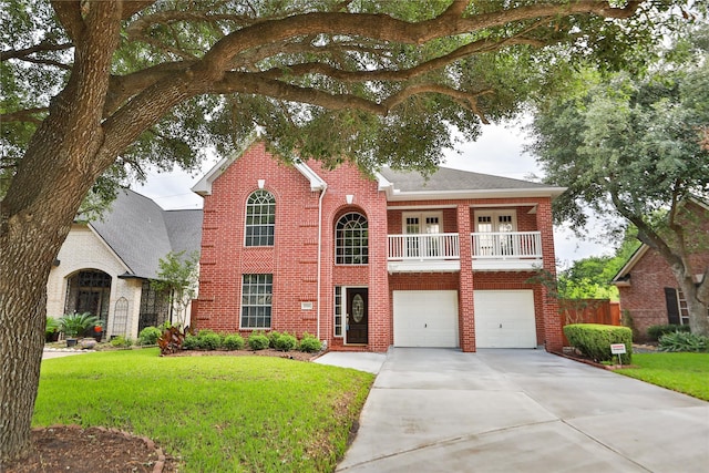 view of front of home with brick siding, a front lawn, concrete driveway, an attached garage, and french doors