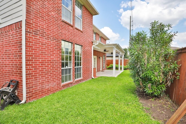 view of yard with a patio and a ceiling fan