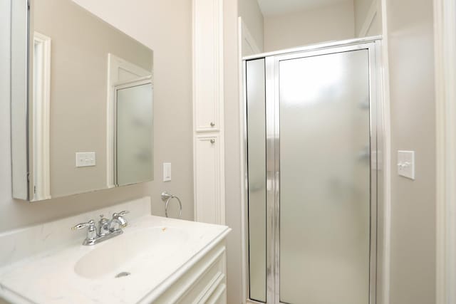 bathroom with a stall shower and vanity