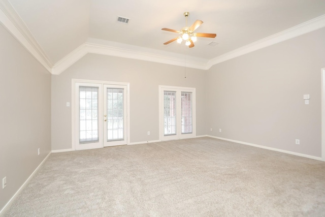 carpeted empty room with a ceiling fan, crown molding, french doors, and baseboards