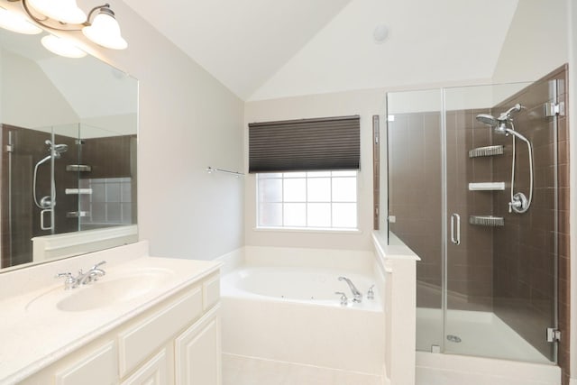 bathroom featuring a shower stall, vaulted ceiling, a garden tub, and vanity
