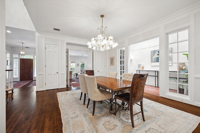 17 Pine Briar Cir, Houston, TX 77056 - dining area featuring wood finished floors, a chandelier, and crown molding