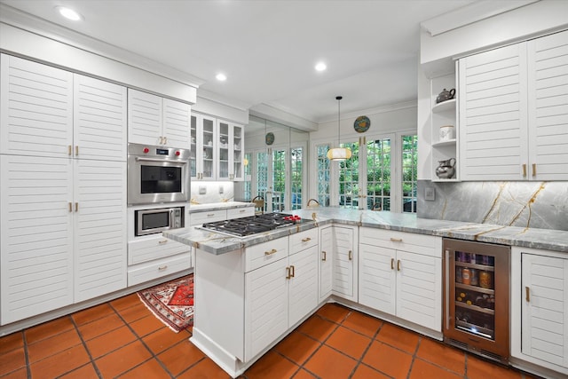 17 Pine Briar Cir, Houston, TX 77056 - kitchen featuring appliances with stainless steel finishes, ornamental molding, wine cooler, a peninsula, and decorative backsplash