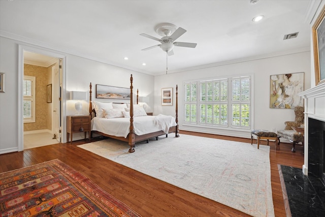17 Pine Briar Cir, Houston, TX 77056 - bedroom with multiple windows, wood finished floors, crown molding, baseboards, and a fireplace