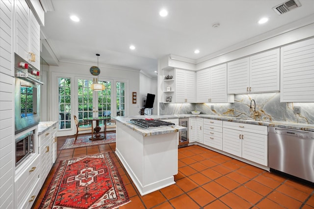 17 Pine Briar Cir, Houston, TX 77056 - kitchen featuring appliances with stainless steel finishes, ornamental molding, french doors, backsplash, and a sink