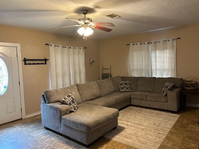 living area with ceiling fan