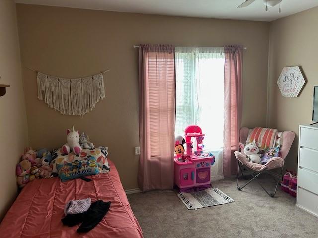carpeted bedroom featuring ceiling fan