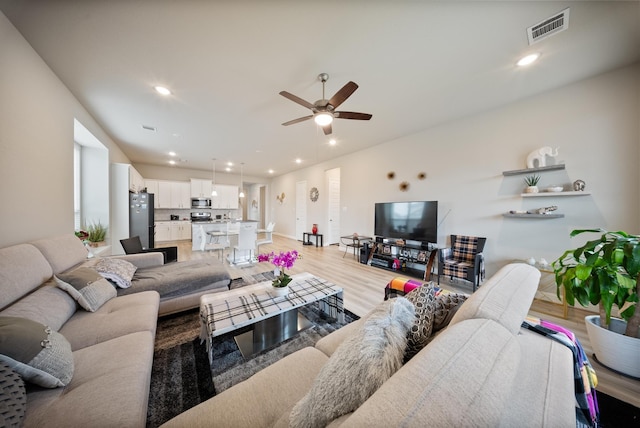 24323 Salts Mill Dr, Katy, TX 77493 - living room featuring light wood-style flooring, a ceiling fan, and recessed lighting