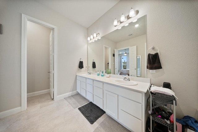 24323 Salts Mill Dr, Katy, TX 77493 - ensuite bathroom featuring double vanity, tile patterned floors, and baseboards