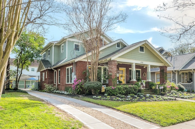 418 Byrne St, Houston, TX 77009 - craftsman-style home with brick siding, a front yard, covered porch, and driveway