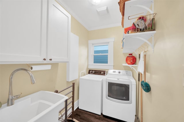 418 Byrne St, Houston, TX 77009 - laundry area with separate washer and dryer, cabinet space, ornamental molding, and dark wood-style floors