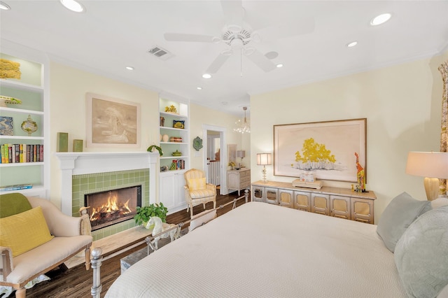 418 Byrne St, Houston, TX 77009 - bedroom with a tiled fireplace, recessed lighting, a ceiling fan, and wood finished floors