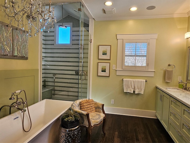 418 Byrne St, Houston, TX 77009 - full bathroom with wood finished floors, a chandelier, vanity, ornamental molding, and a shower stall