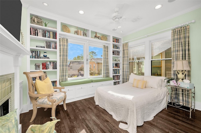 418 Byrne St, Houston, TX 77009 - bedroom with a tiled fireplace, dark wood-type flooring, ornamental molding, and recessed lighting