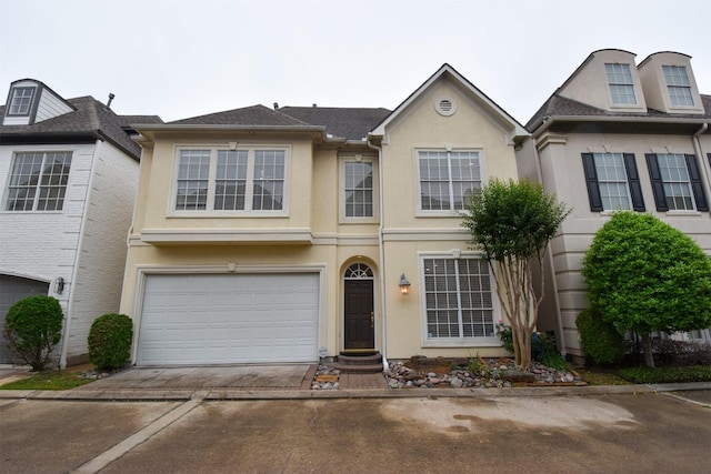3226 Pemberton Circle Dr, Houston, TX 77025 - view of property with stucco siding, concrete driveway, and an attached garage