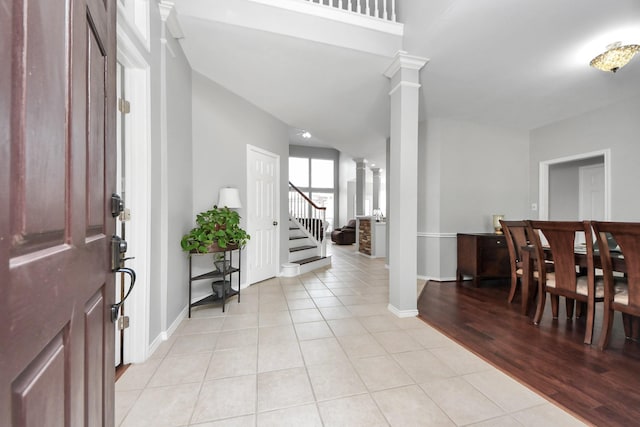 8742 Melting Shadows Ln, Houston, TX 77095 - entrance foyer featuring decorative columns, light tile patterned floors, stairway, and baseboards