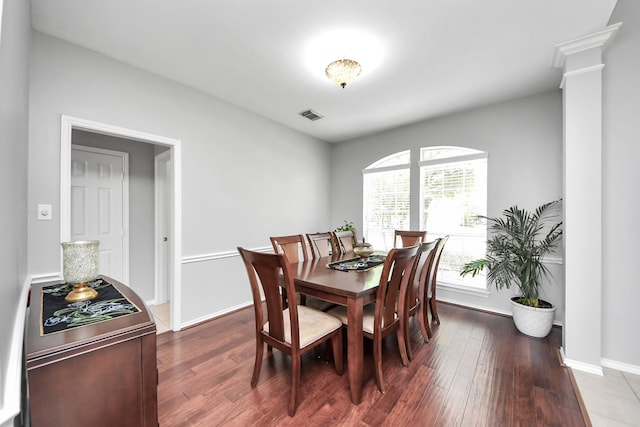 8742 Melting Shadows Ln, Houston, TX 77095 - dining area featuring decorative columns, wood finished floors, and baseboards