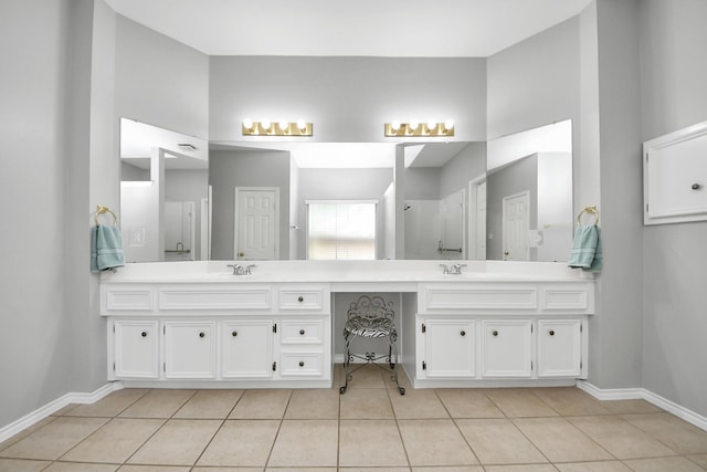 8742 Melting Shadows Ln, Houston, TX 77095 - bathroom with tile patterned flooring, double vanity, baseboards, and a shower