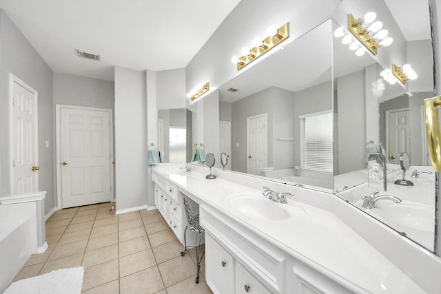 8742 Melting Shadows Ln, Houston, TX 77095 - bathroom with tile patterned flooring, double vanity, a tub to relax in, and baseboards