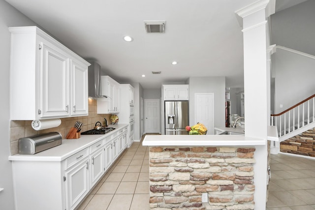 8742 Melting Shadows Ln, Houston, TX 77095 - kitchen featuring stainless steel appliances, light tile patterned flooring, wall chimney range hood, tasteful backsplash, and white cabinets