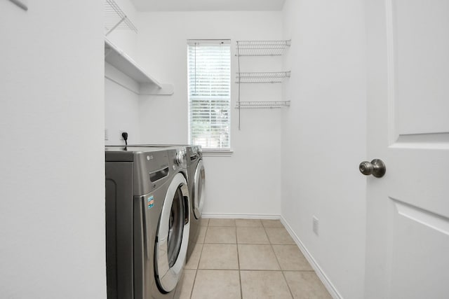 8742 Melting Shadows Ln, Houston, TX 77095 - clothes washing area with washer and dryer, light tile patterned floors, and baseboards