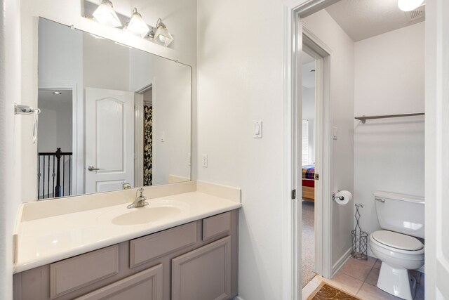 2107 Pearl Bay Ct, Pearland, TX 77584 - bathroom featuring tile patterned floors, toilet, and vanity