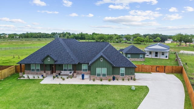 9603 Neon Moon Dr, Needville, TX 77461 - back of property featuring a shingled roof, covered porch, board and batten siding, concrete driveway, and stone siding