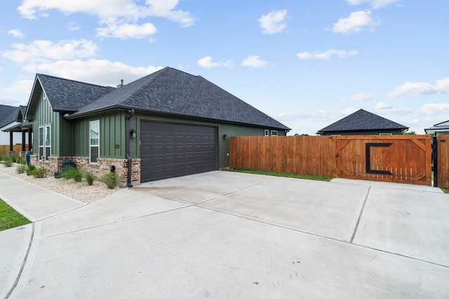 9603 Neon Moon Dr, Needville, TX 77461 - view of side of property featuring a shingled roof, fence, an attached garage, and a gate