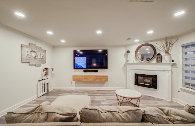 2519 Bradburn Hill Ln, Houston, TX 77014 - living room with recessed lighting, baseboards, a glass covered fireplace, crown molding, and wood finished floors