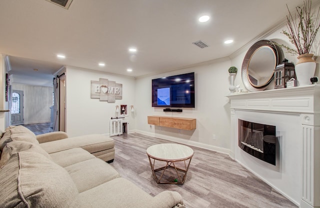 2519 Bradburn Hill Ln, Houston, TX 77014 - living area with a barn door, recessed lighting, wood finished floors, a fireplace, and baseboards