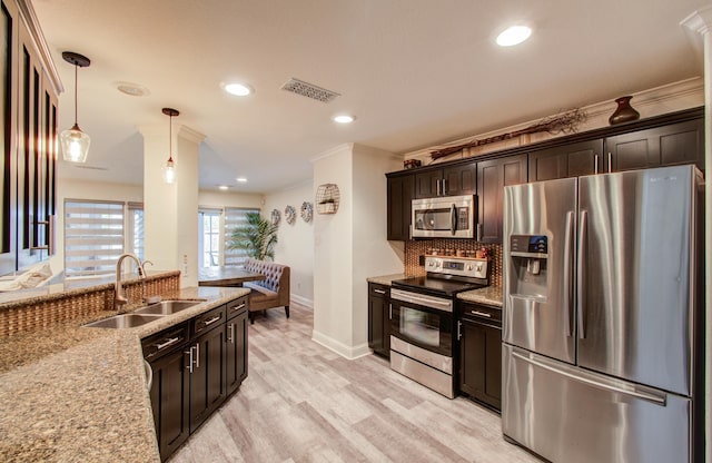 2519 Bradburn Hill Ln, Houston, TX 77014 - kitchen featuring stainless steel appliances, a sink, light stone counters, light wood finished floors, and pendant lighting