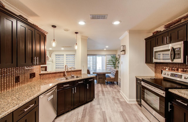 2519 Bradburn Hill Ln, Houston, TX 77014 - kitchen featuring stainless steel appliances, a sink, decorative backsplash, light wood-style floors, and dark brown cabinets