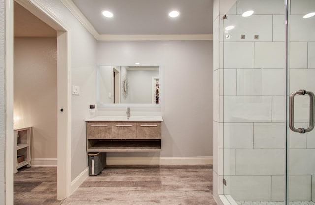 2519 Bradburn Hill Ln, Houston, TX 77014 - bathroom with crown molding, wood finished floors, a shower stall, baseboards, and vanity