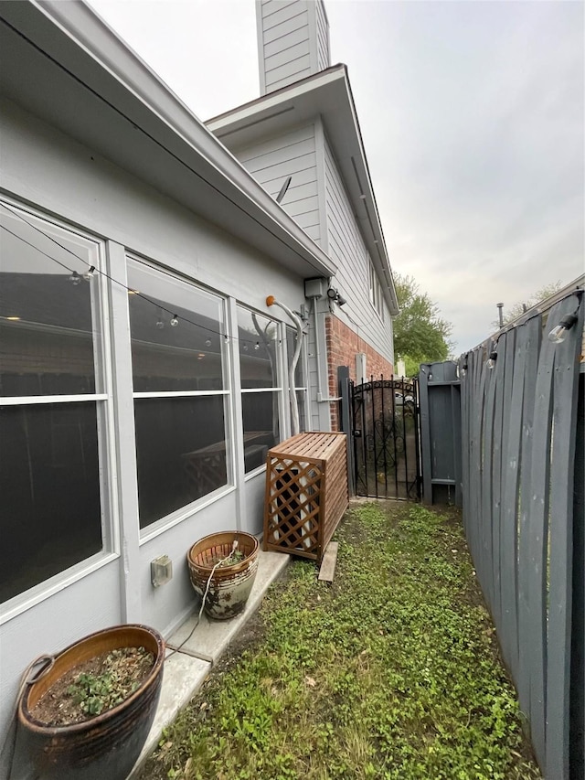 2519 Bradburn Hill Ln, Houston, TX 77014 - view of side of property with brick siding, a gate, and a chimney
