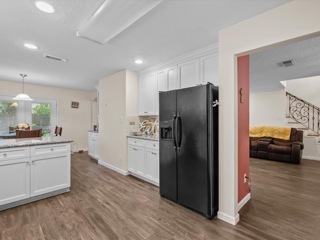 1814 Oak Valley Dr, Kemah, TX 77565 - kitchen with black refrigerator with ice dispenser, white cabinetry, wood finished floors, baseboards, and recessed lighting