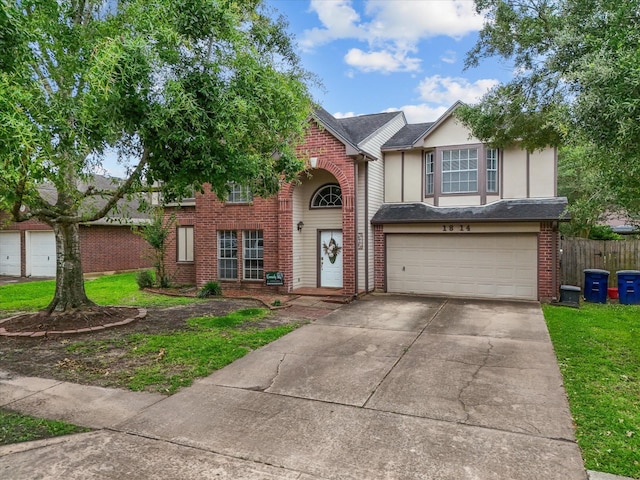 1814 Oak Valley Dr, Kemah, TX 77565 - traditional-style house featuring an attached garage, driveway, brick siding, and stucco siding