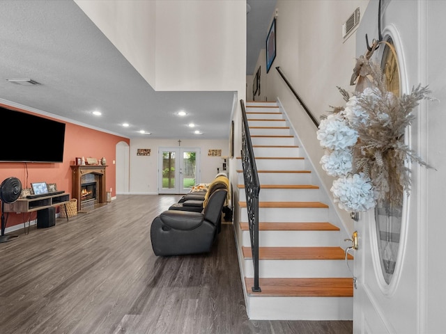 1814 Oak Valley Dr, Kemah, TX 77565 - stairs with a lit fireplace, wood finished floors, recessed lighting, and baseboards