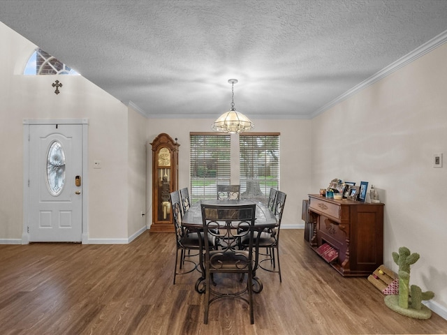 1814 Oak Valley Dr, Kemah, TX 77565 - dining area featuring wood finished floors, a textured ceiling, baseboards, crown molding, and a chandelier
