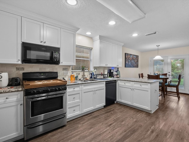 1814 Oak Valley Dr, Kemah, TX 77565 - kitchen featuring black appliances, white cabinetry, dark wood finished floors, tasteful backsplash, and recessed lighting