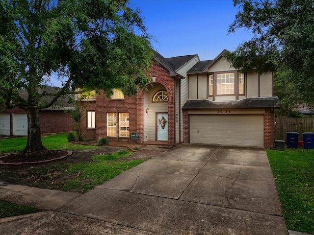 1814 Oak Valley Dr, Kemah, TX 77565 - traditional-style home with an attached garage, driveway, brick siding, and fence