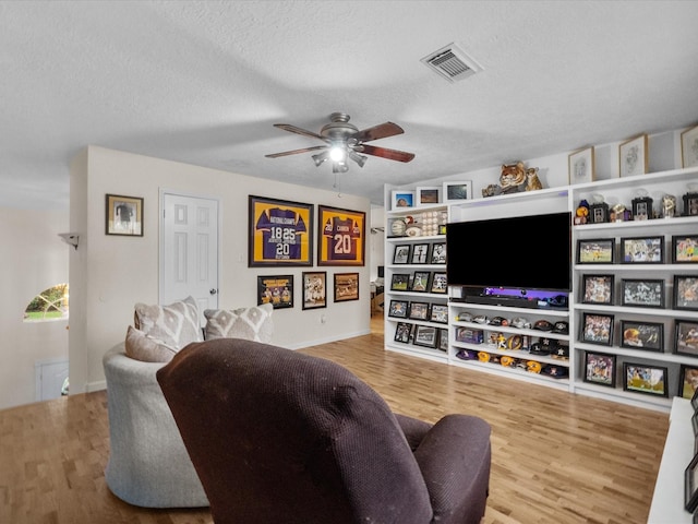 1814 Oak Valley Dr, Kemah, TX 77565 - living room featuring ceiling fan, wood finished floors, a textured ceiling, and baseboards