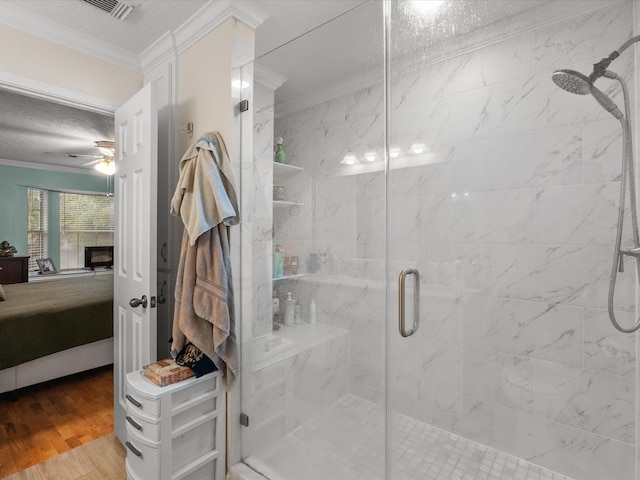 1814 Oak Valley Dr, Kemah, TX 77565 - ensuite bathroom featuring ornamental molding, a stall shower, ceiling fan, wood finished floors, and a textured ceiling