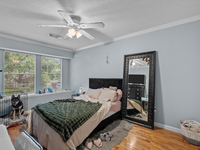 1814 Oak Valley Dr, Kemah, TX 77565 - bedroom with wood finished floors, a textured ceiling, ornamental molding, baseboards, and ceiling fan