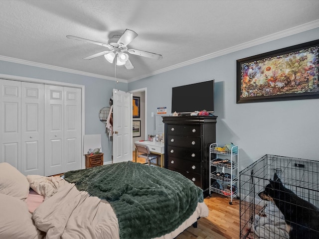 1814 Oak Valley Dr, Kemah, TX 77565 - bedroom with wood finished floors, a closet, crown molding, ceiling fan, and a textured ceiling