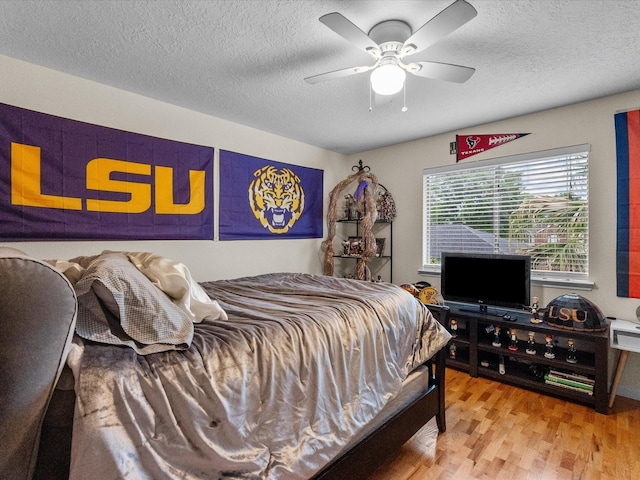 1814 Oak Valley Dr, Kemah, TX 77565 - bedroom featuring wood finished floors, a textured ceiling, and a ceiling fan