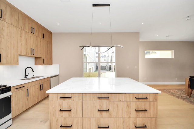 kitchen featuring light brown cabinetry, a sink, light wood-style flooring, and recessed lighting